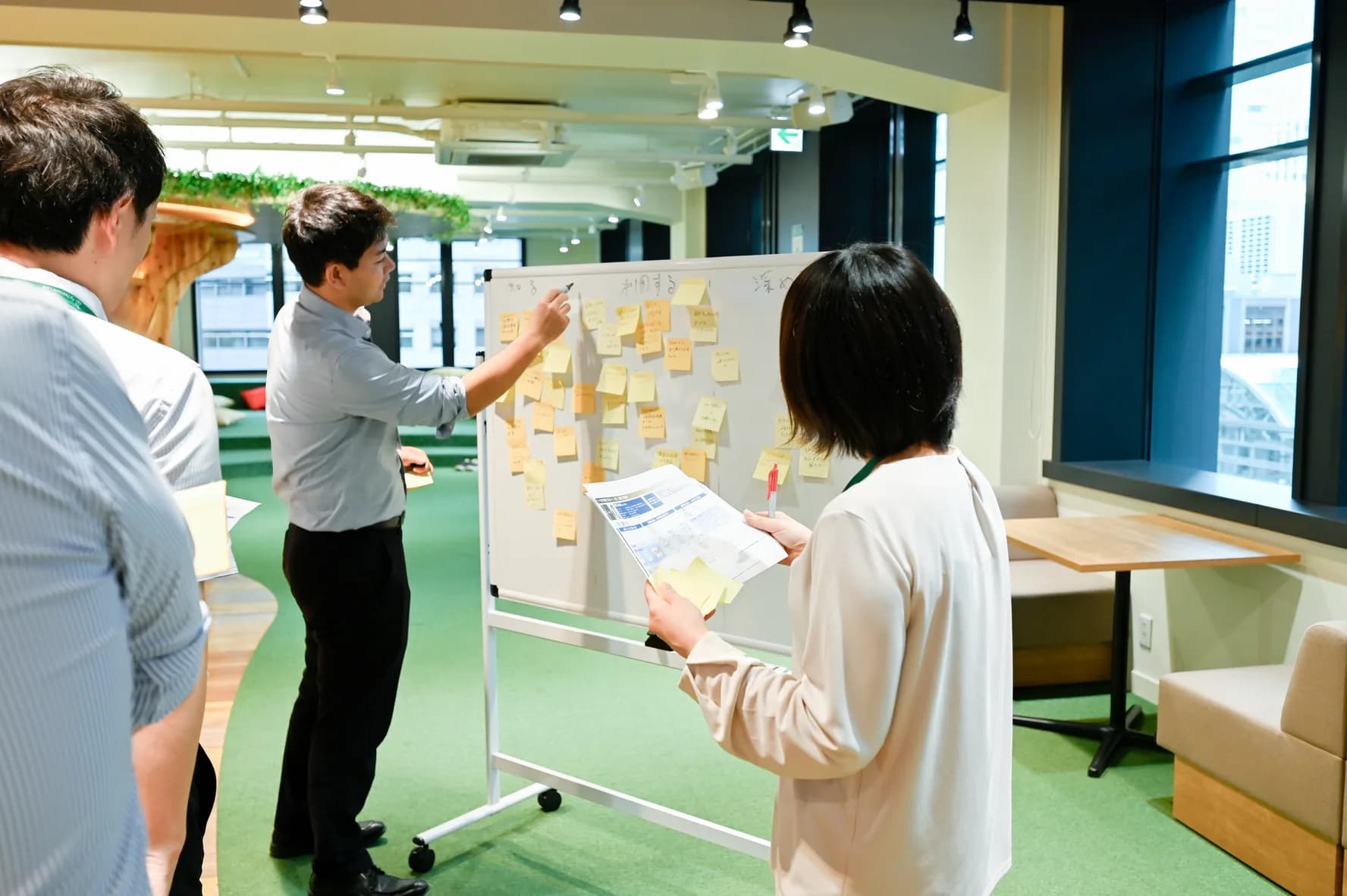 ホワイトボードに付箋を貼りながら議論するAgVenture Labのメンバー